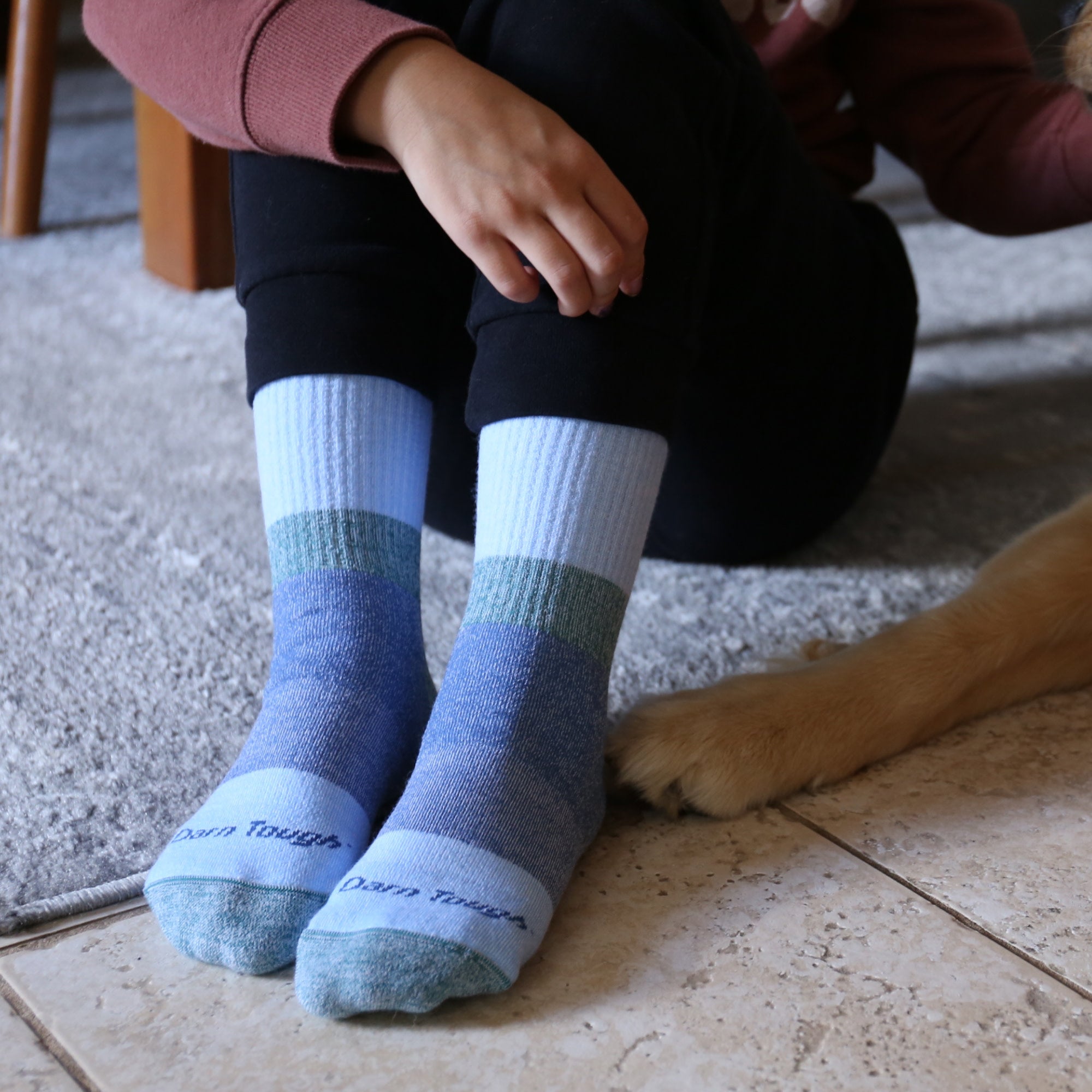 model sitting on the floor with dog wearing the 3045 hill topper micro crew in dragonfly colorway