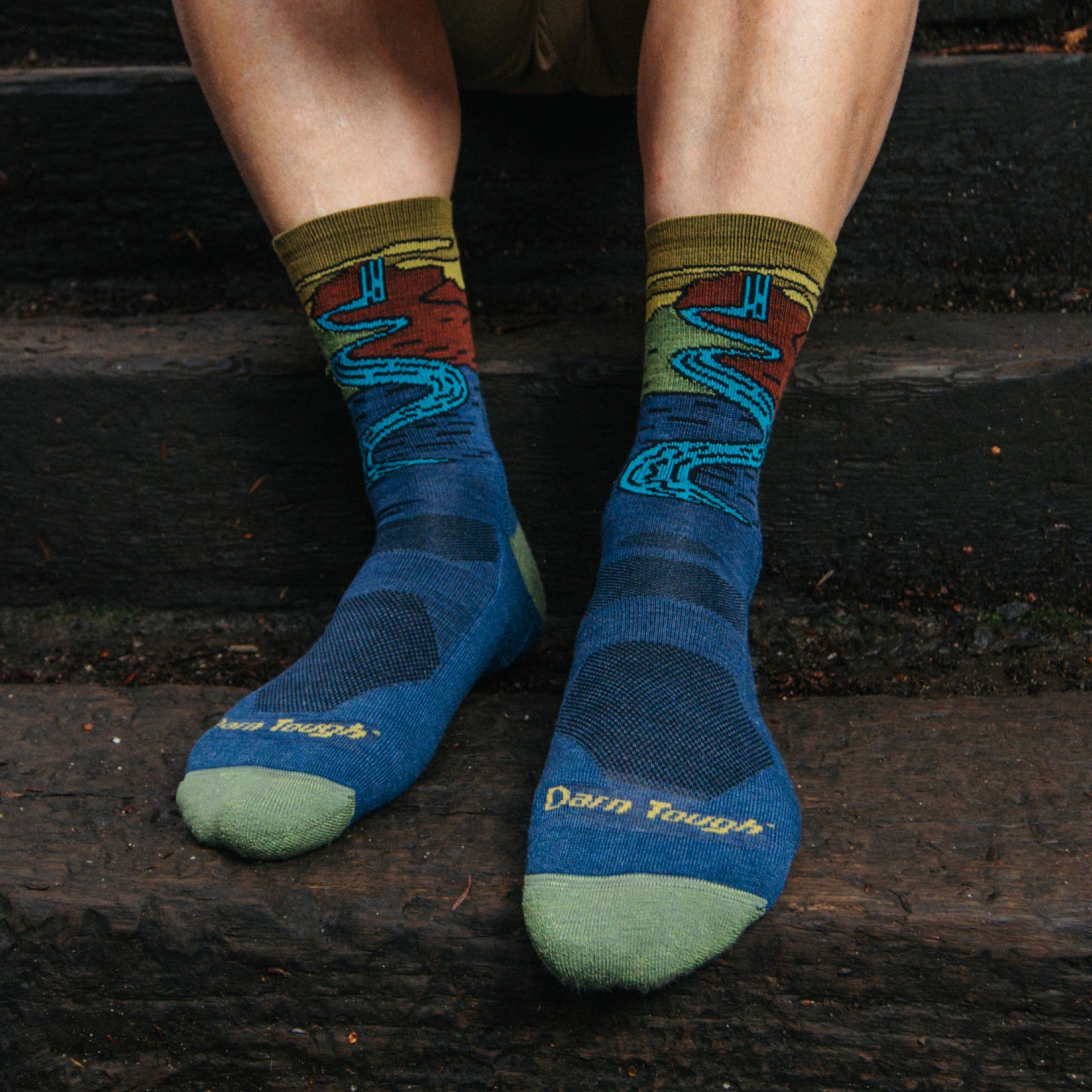 Models feet on wooden step wearing the 5020 chasing waterfalls Micro Crew hiking sock in Denim