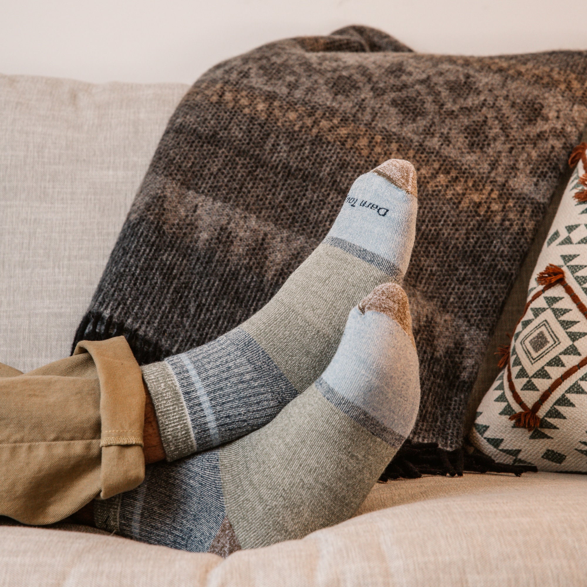 Models feet up on couch crossed wearing the 6118 heavyweight shorty in canteen colorway