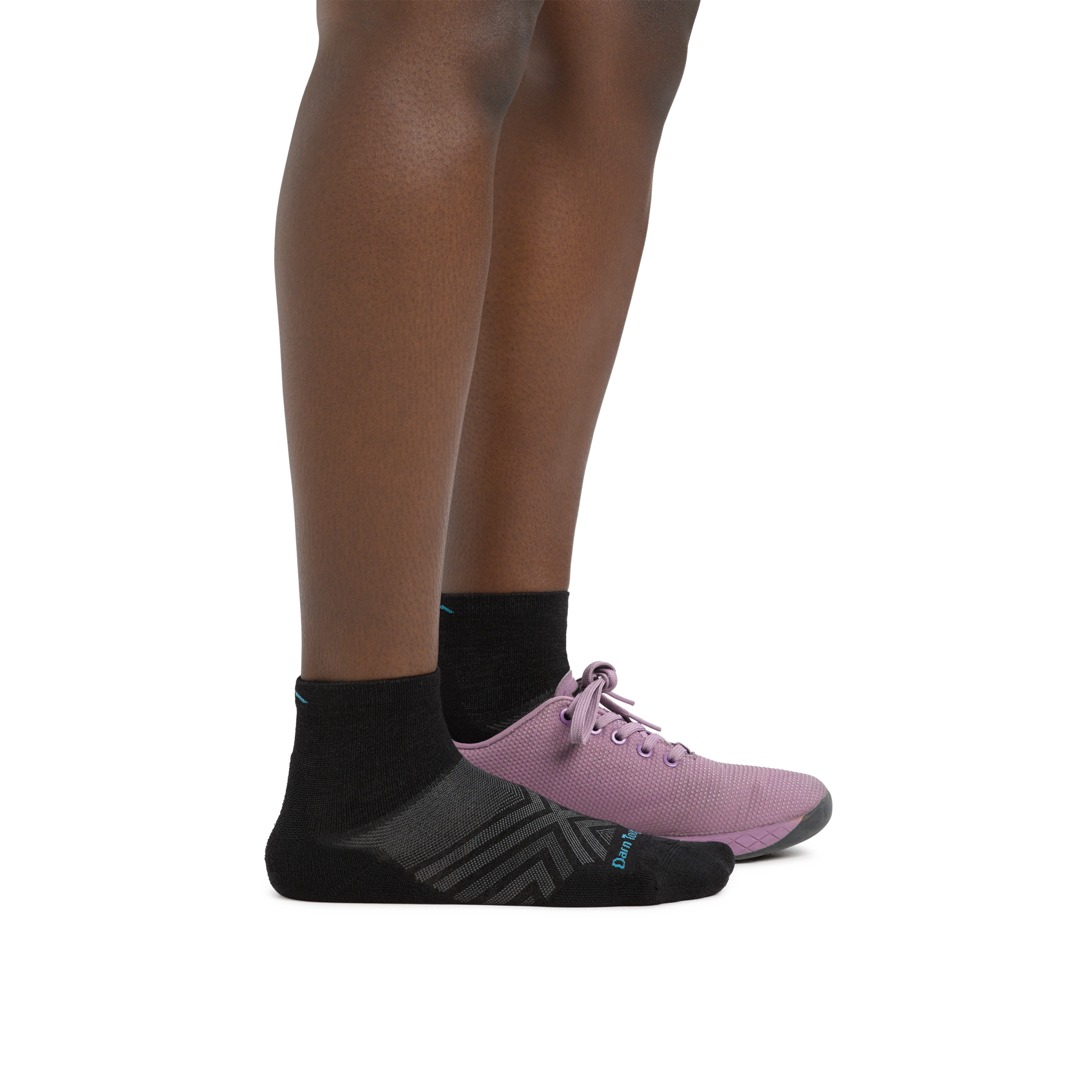 Woman wearing Women's Run Quarter Ultra-Lightweight Running Socks in Black with a running shoe on one foot