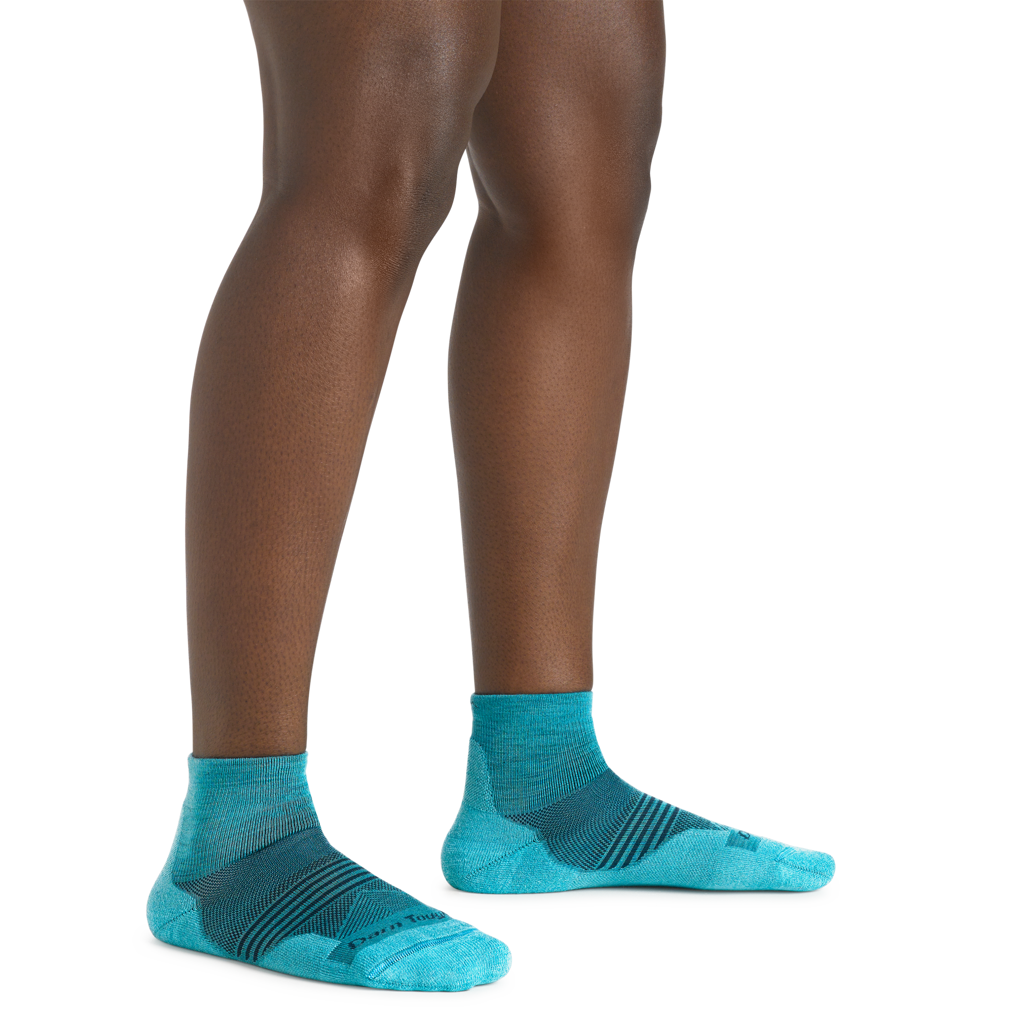 Close up shot of model wearing the women's element quarter height running sock in cyan with no shoes on
