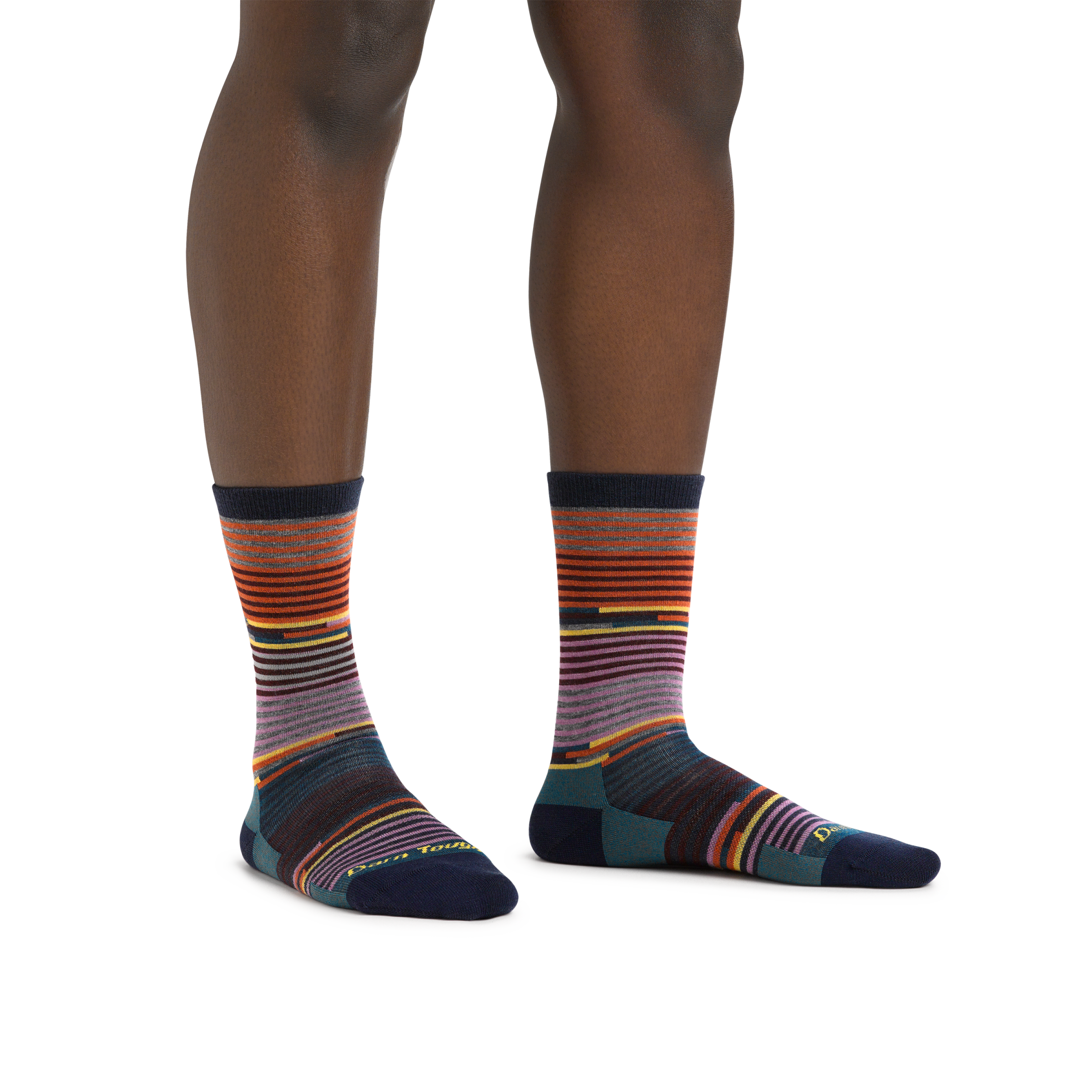 Image of a woman's legs, standing on a white background wearing Women's Pixie Crew Lightweight Lifestyle Socks in Navy