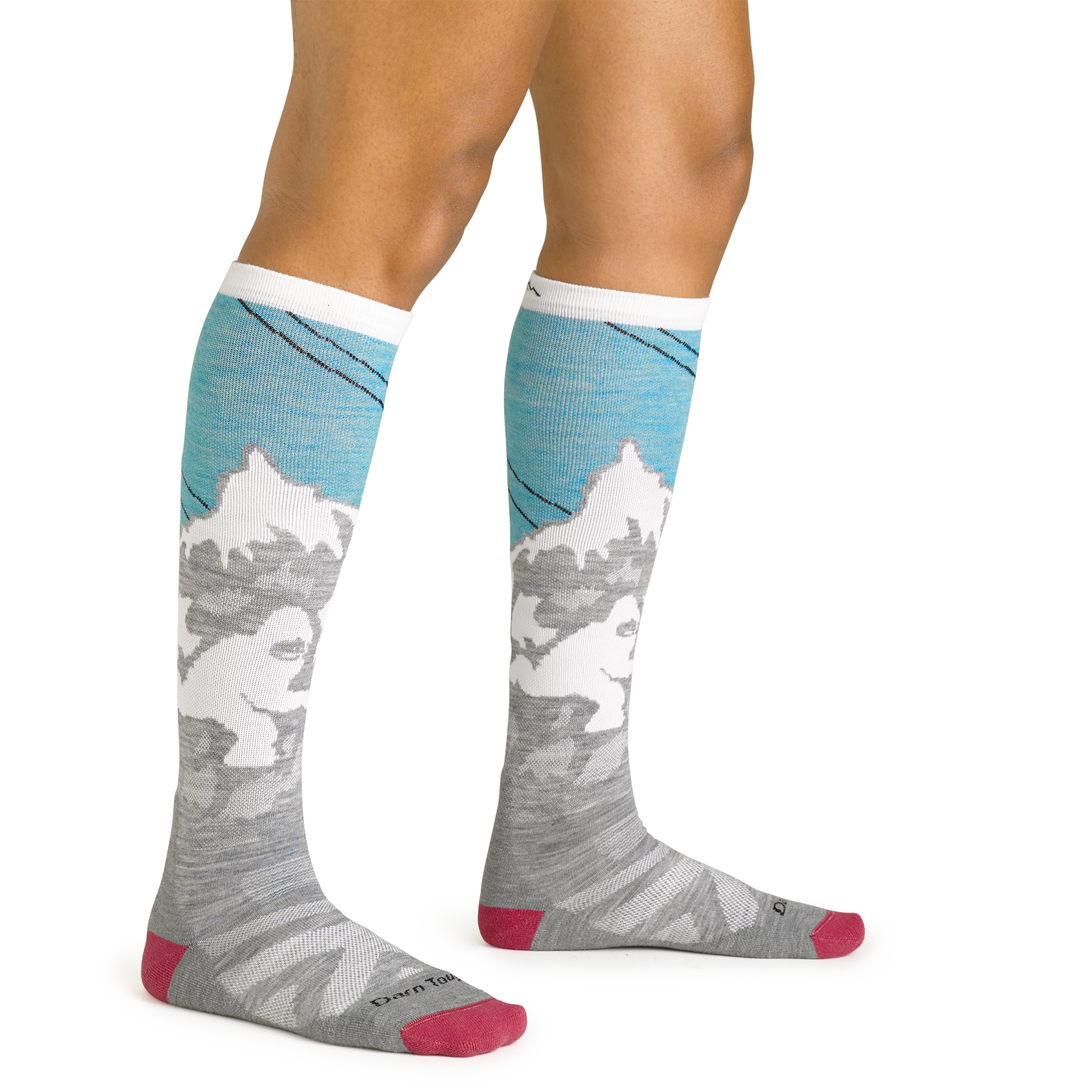 Close up studio shot of model wearing women's yeti over-the-calf midweight ski & snowboard sock in aqua