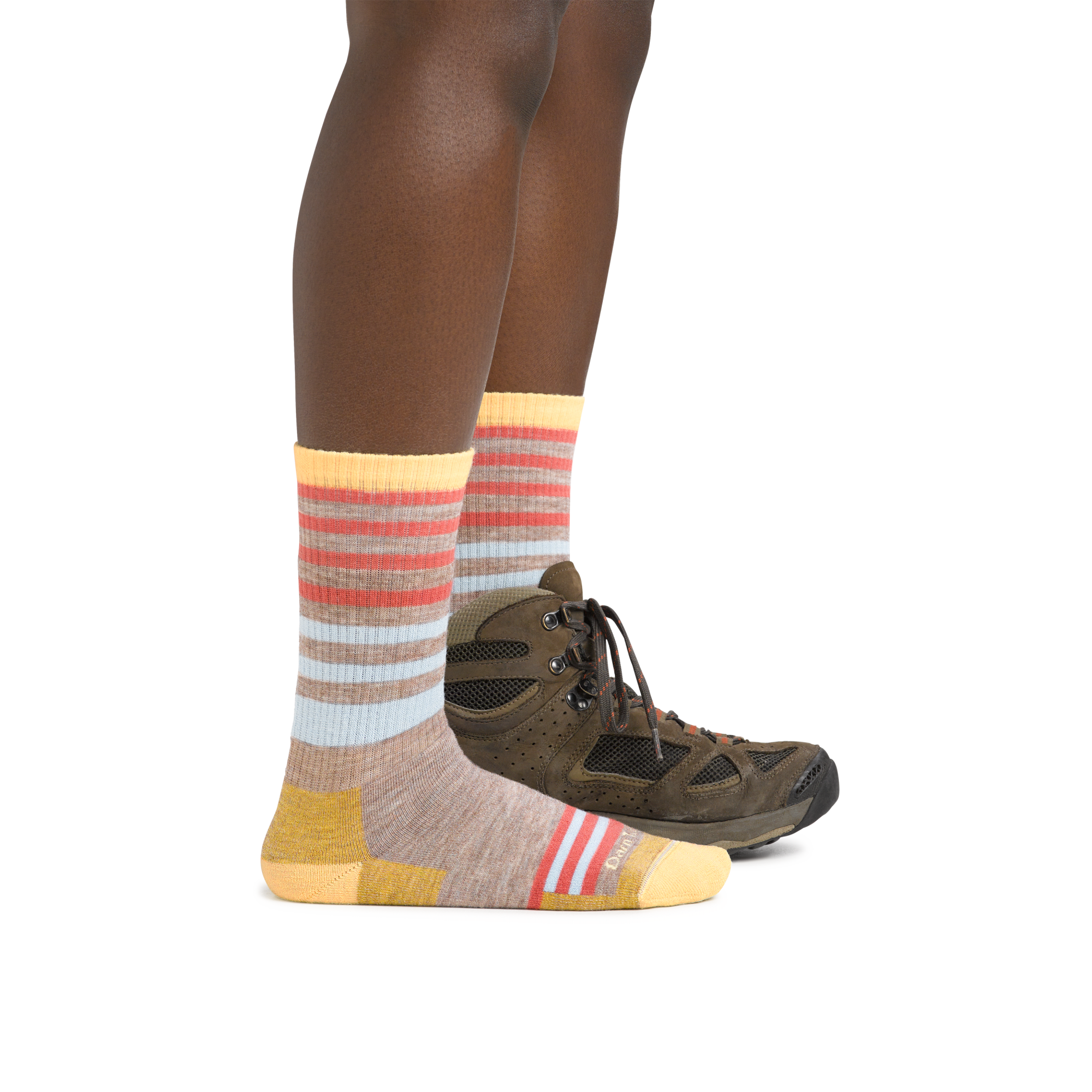 Woman wearing Women's Gatewood Boot Midweight Hiking Sock in Oatmeal and a hiking boot