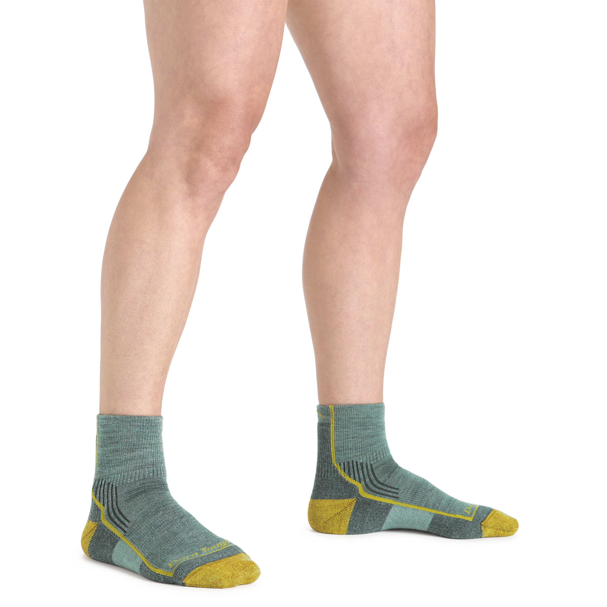 Woman's legs standing on a white background wearing Women's Hiker Quarter Midweight Hiking Socks in sage color