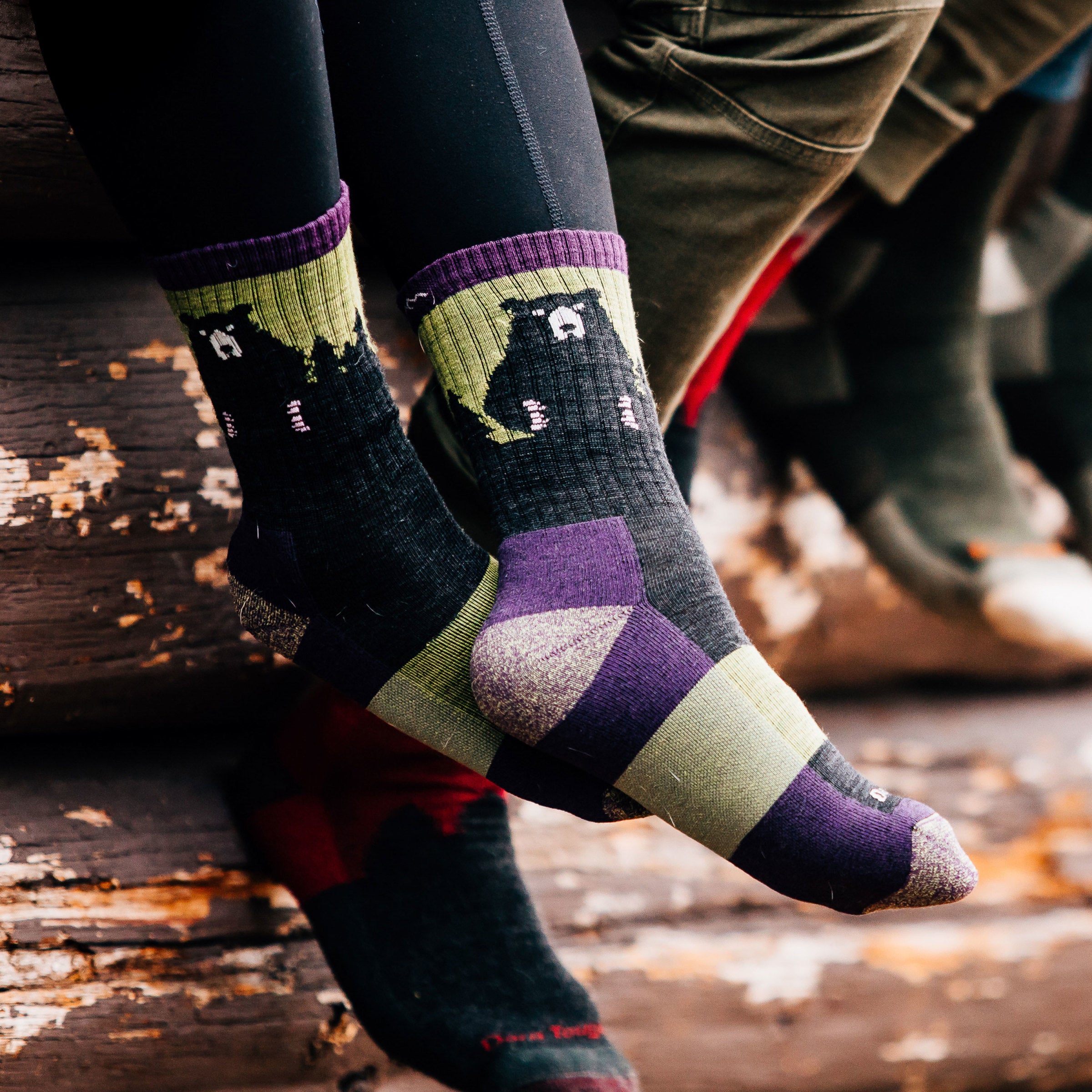 Woman's feet, crossed at the ankles wearing Women's Bear Town Micro Crew Lightweight Hiking Socks in Lime