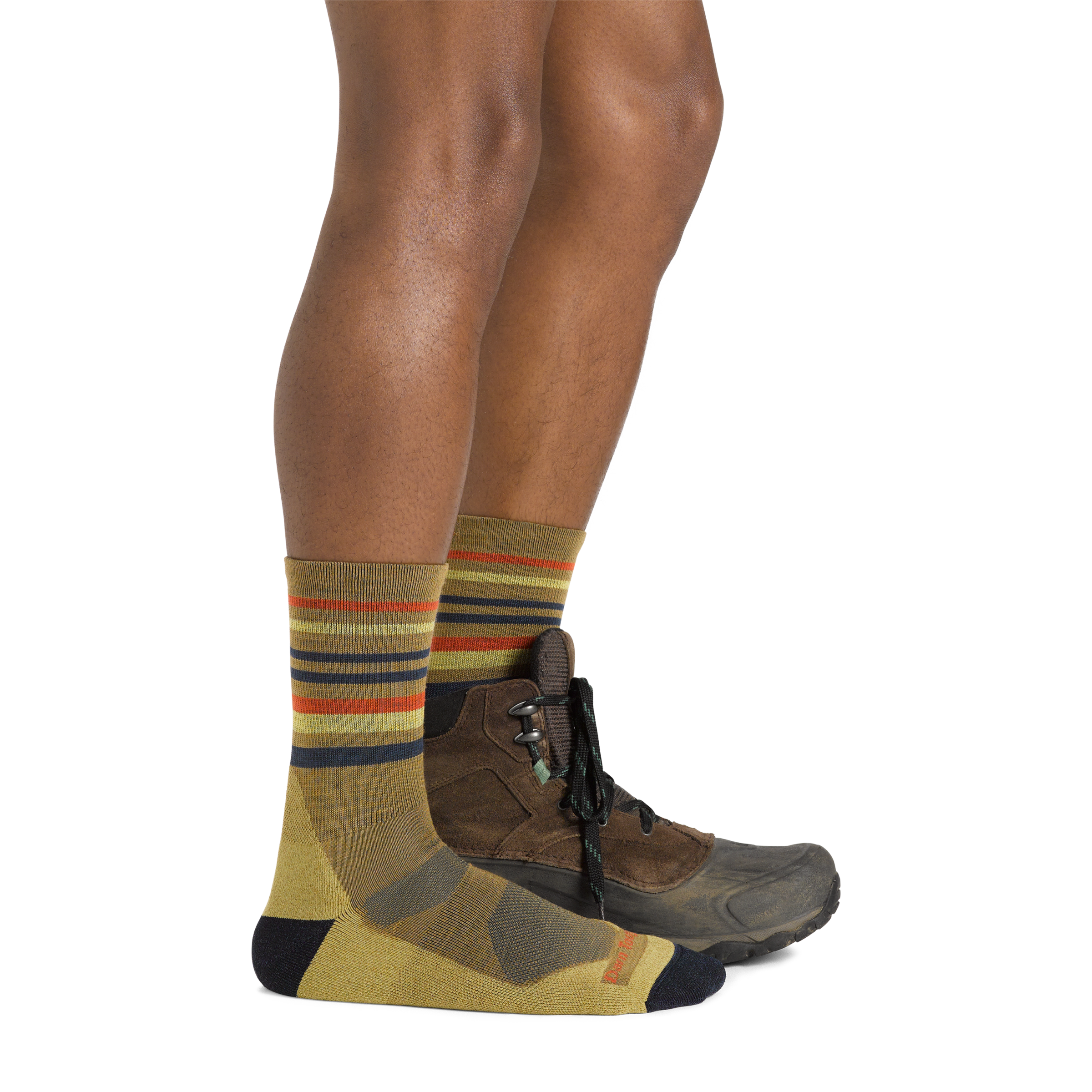 Side shot of model wearing the men's fastpack micro crew hiking socks in sandstone with a gray sneaker on his left foot