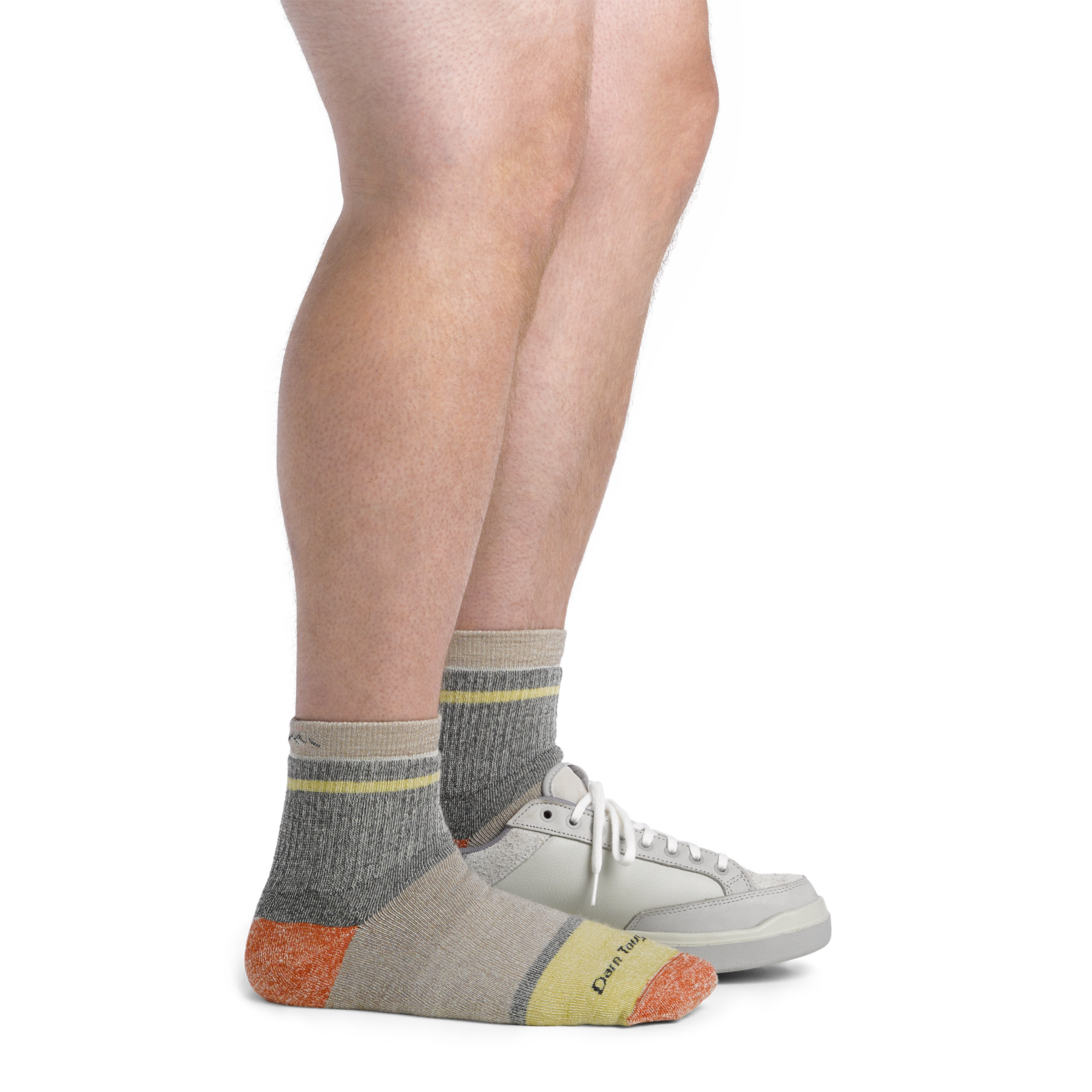 Image of model wearing 6118 Men's shorty socks and a gray sneaker on one foot