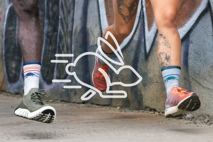 Feet wearing merino wool running socks, the best socks to prevent blisters, with a speed icon