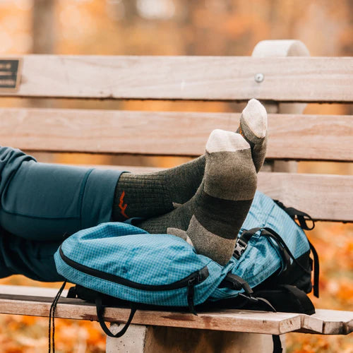 Person with feet upon bench taking a nap in comfortable socks