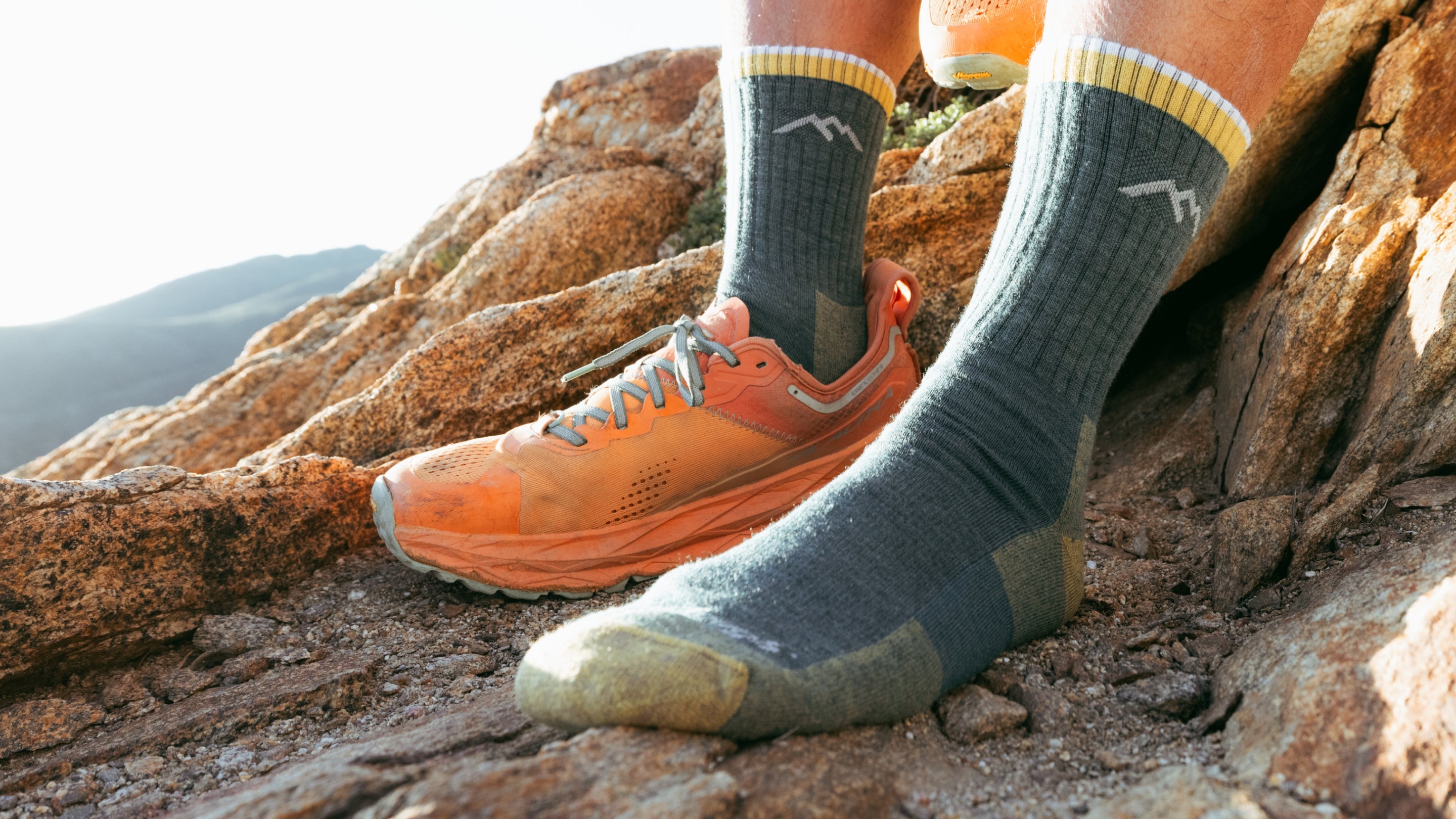 Models feet on rocky mountain top wearing the 1466 Micro crew hiker in spruce