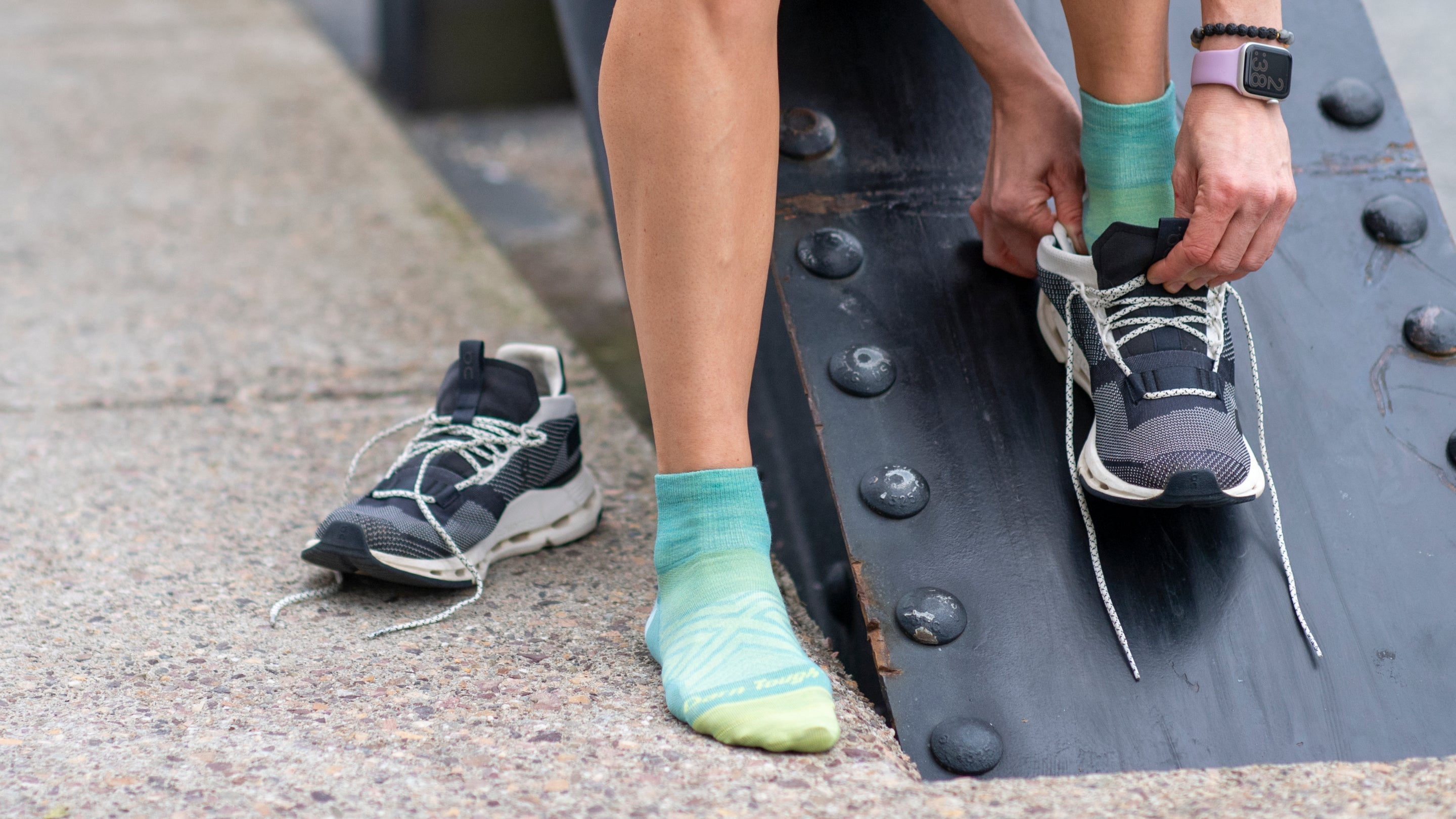 Close up on model featuring the Women's Ultra-Lightweight Quarter Running sock in aqua