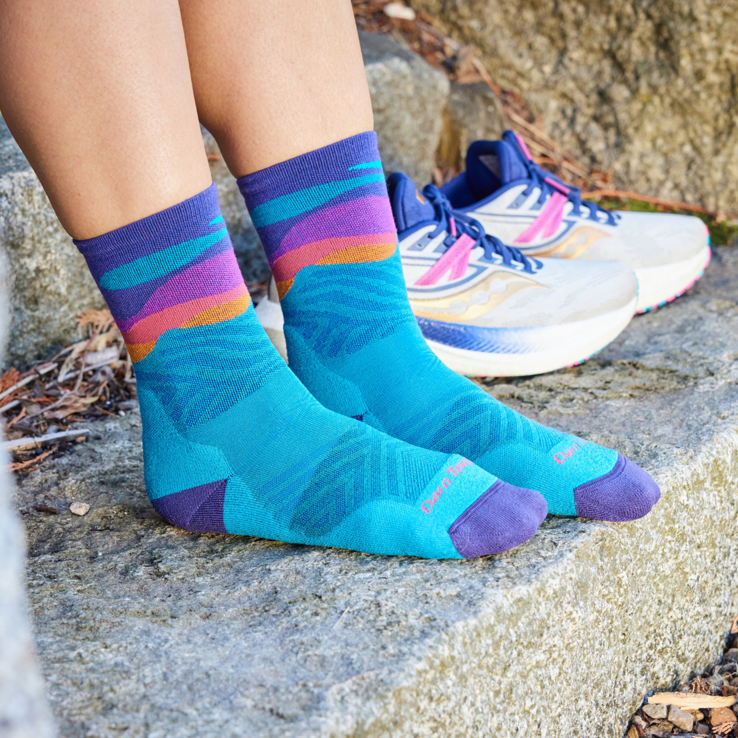 Models feet on stone step wearing the 1067 Mirnavated Micro Crew Running sock in Cascade