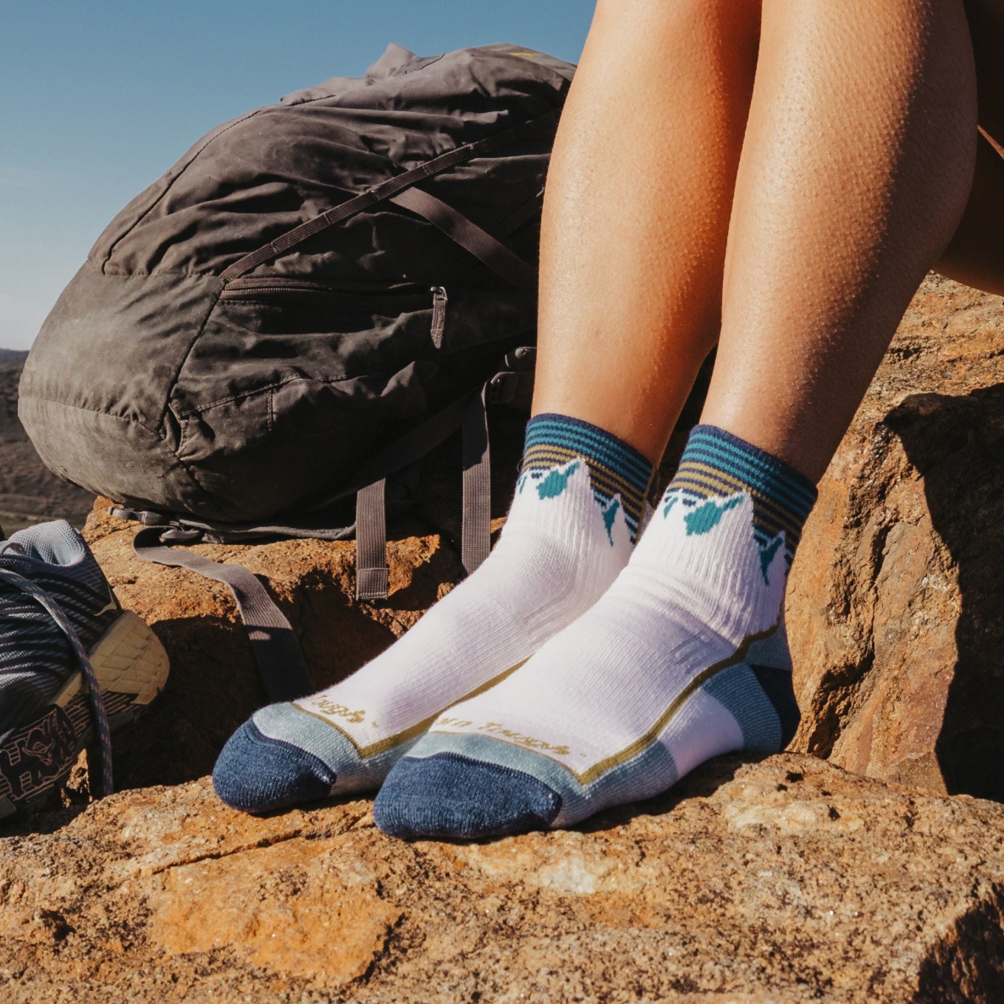 Models feet on rocks wearing the 1958 quarter midweight hiker in white colorway