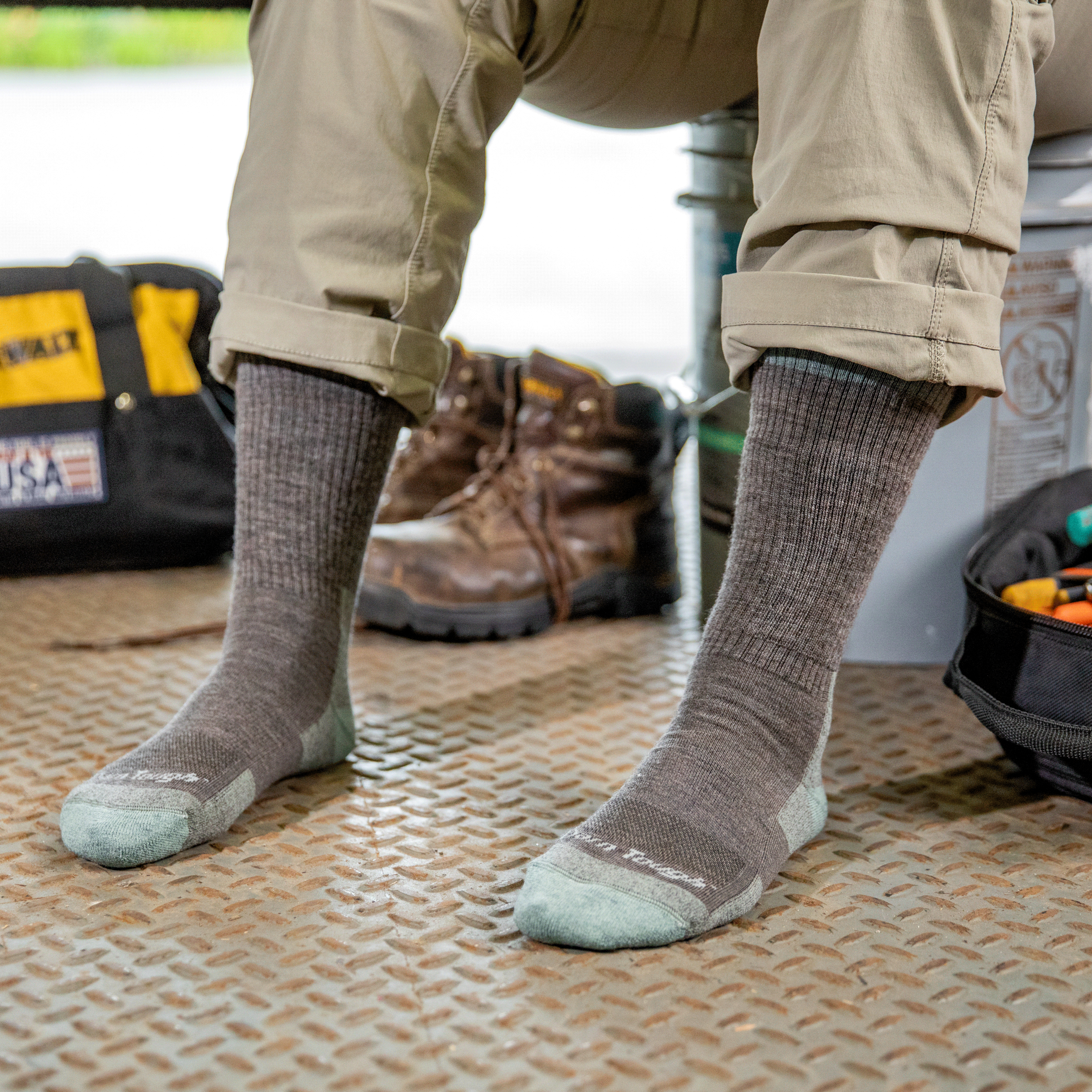 Worker's feet wearing merino wool RTR work boot socks in shale