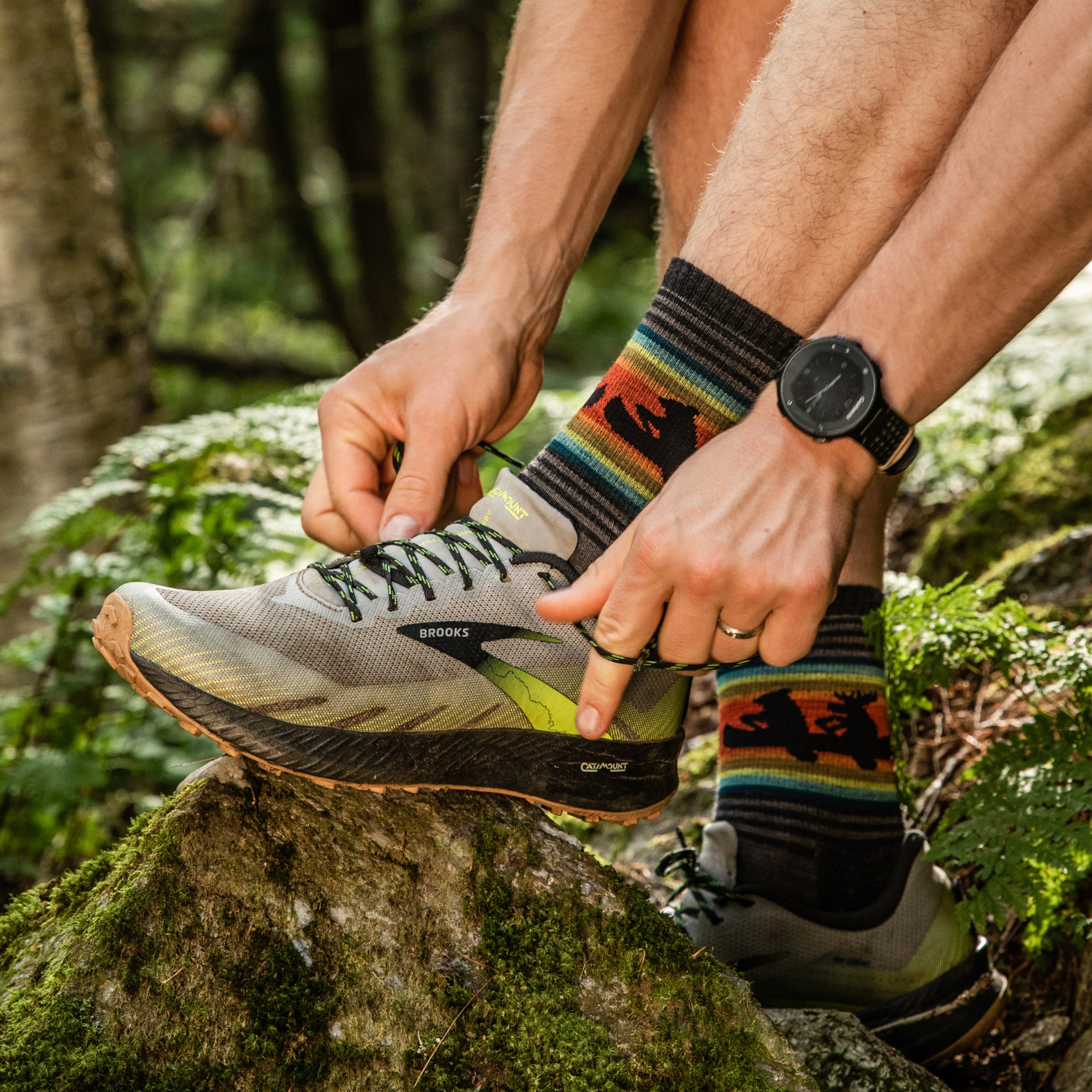 Hiker on the trail adjusting his laces wearing the Willoughby micro crew hiking socks in Taupe