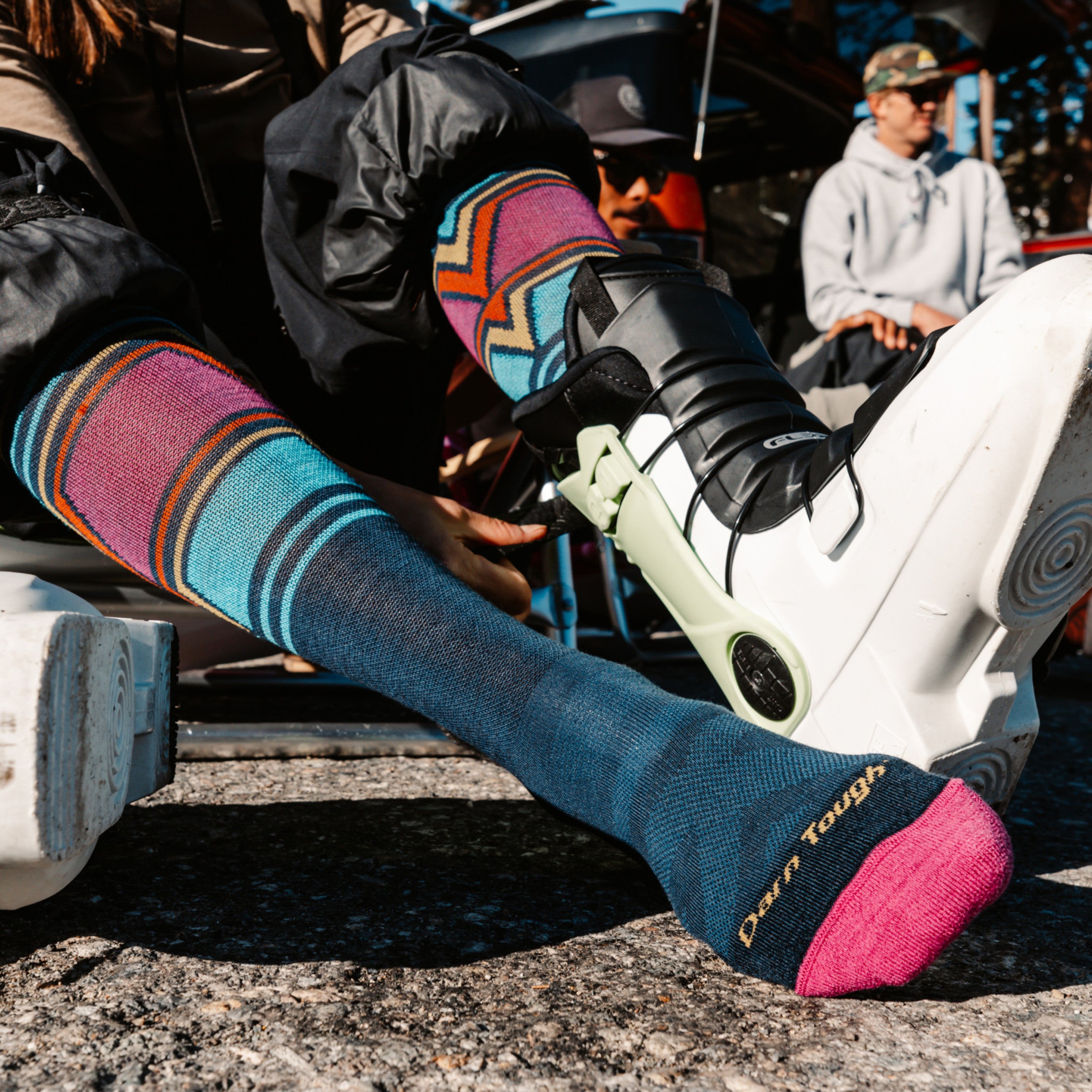 close up of model putting on ski boot wearing 8048 Eclipse on front foot 