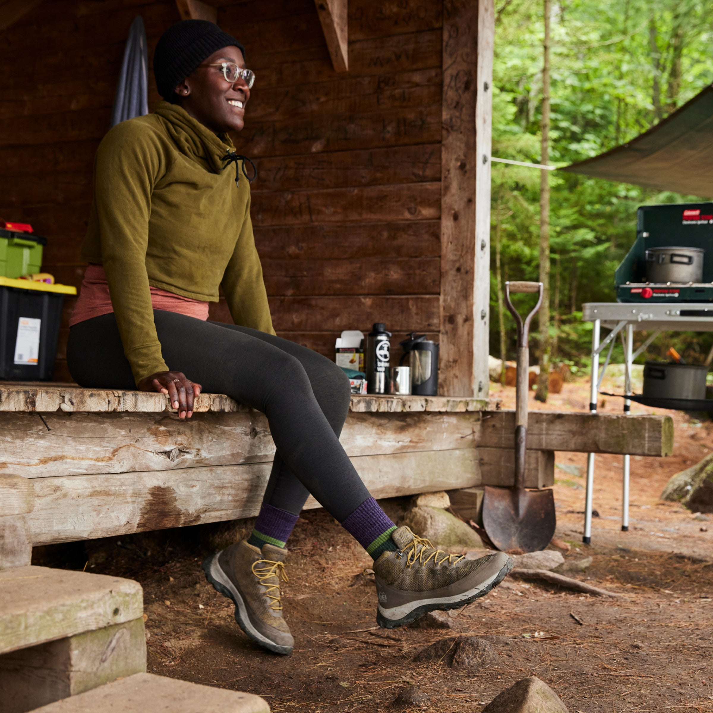 Model sitting in leanto wearing 5002 Moss