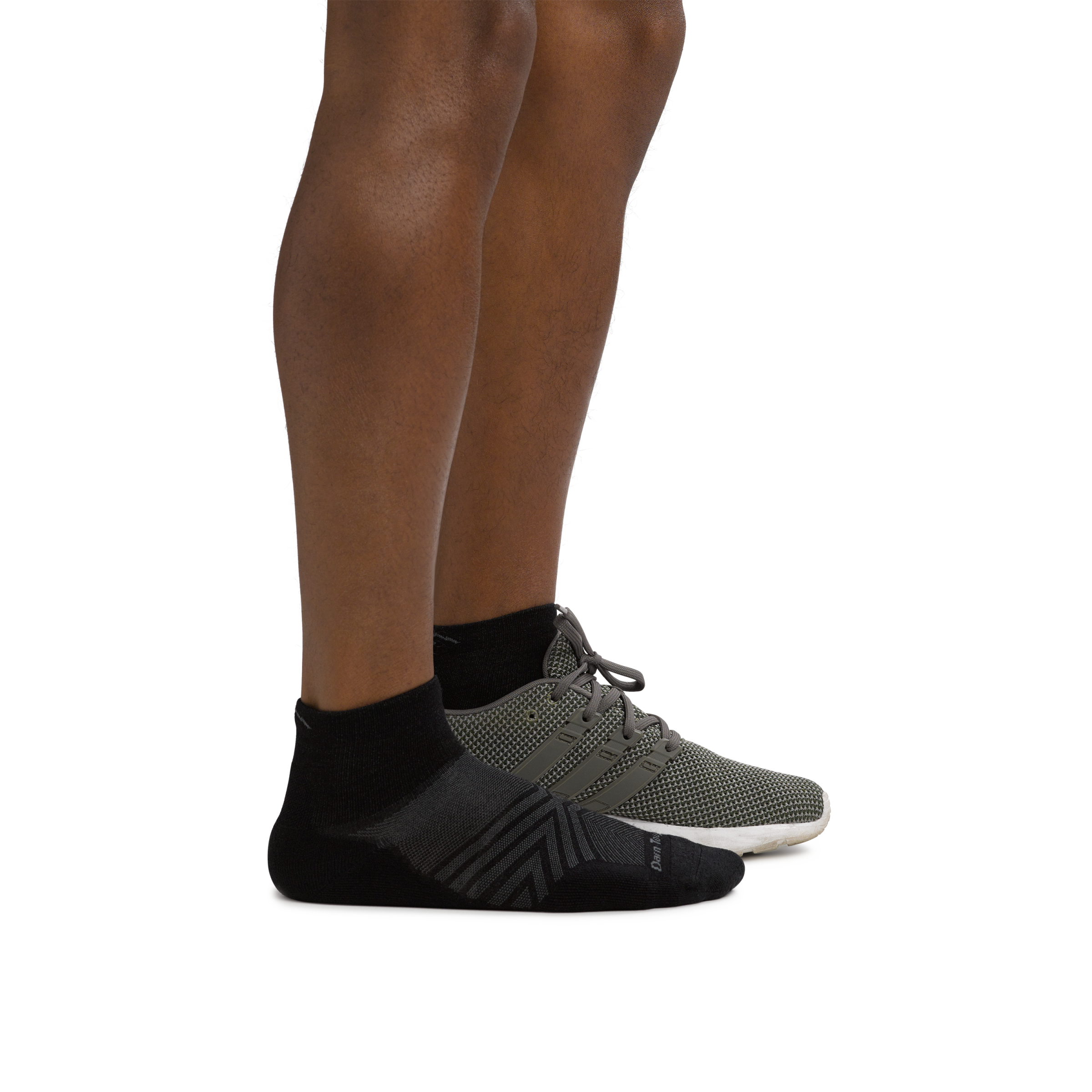 Man facing right wearing Coolmax Run Quarter Ultra-Lightweight Running Sock in Black with back foot in a running shoe