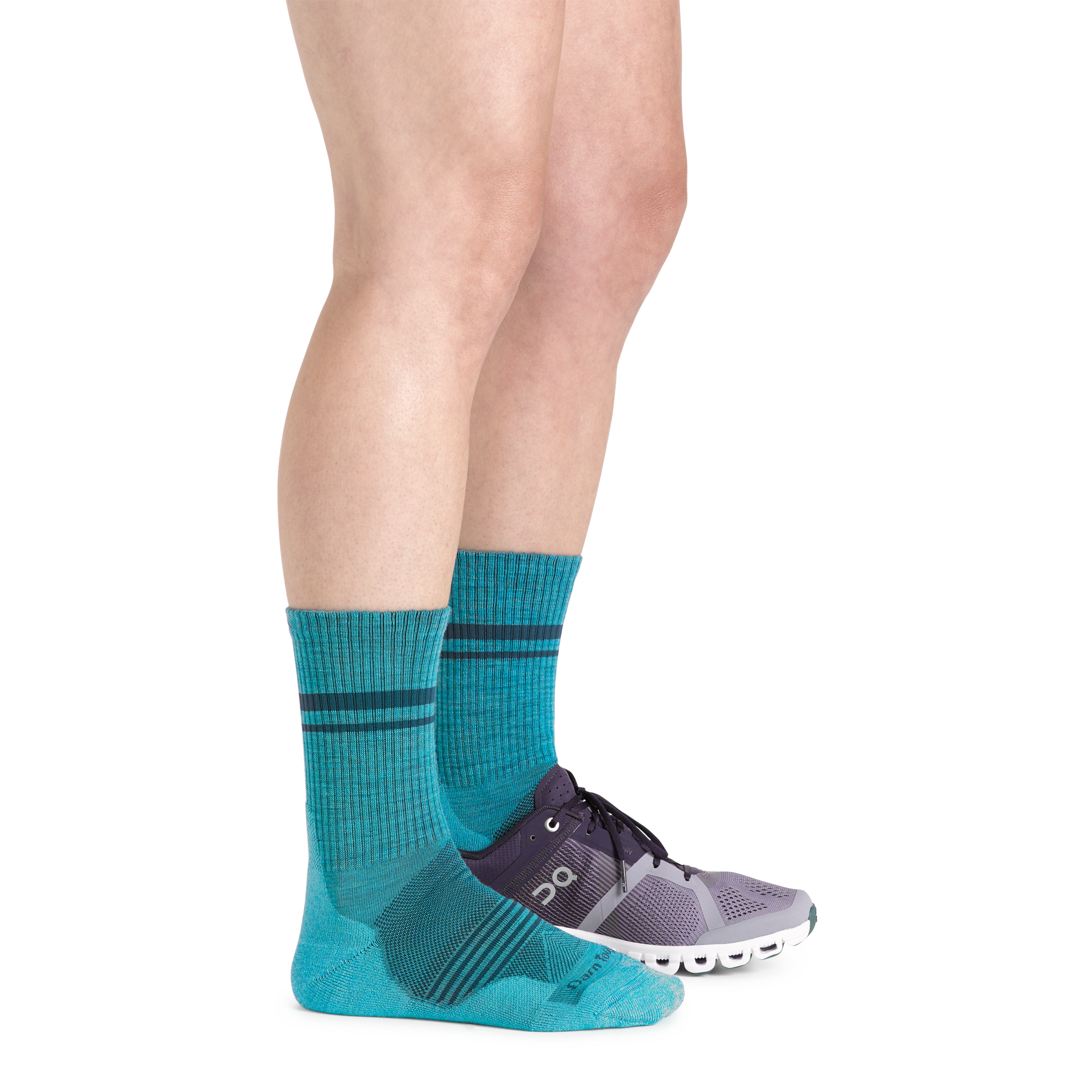 Side studio shot of model wearing women's element micro crew running sock in cyan with purple sneaker on left foot