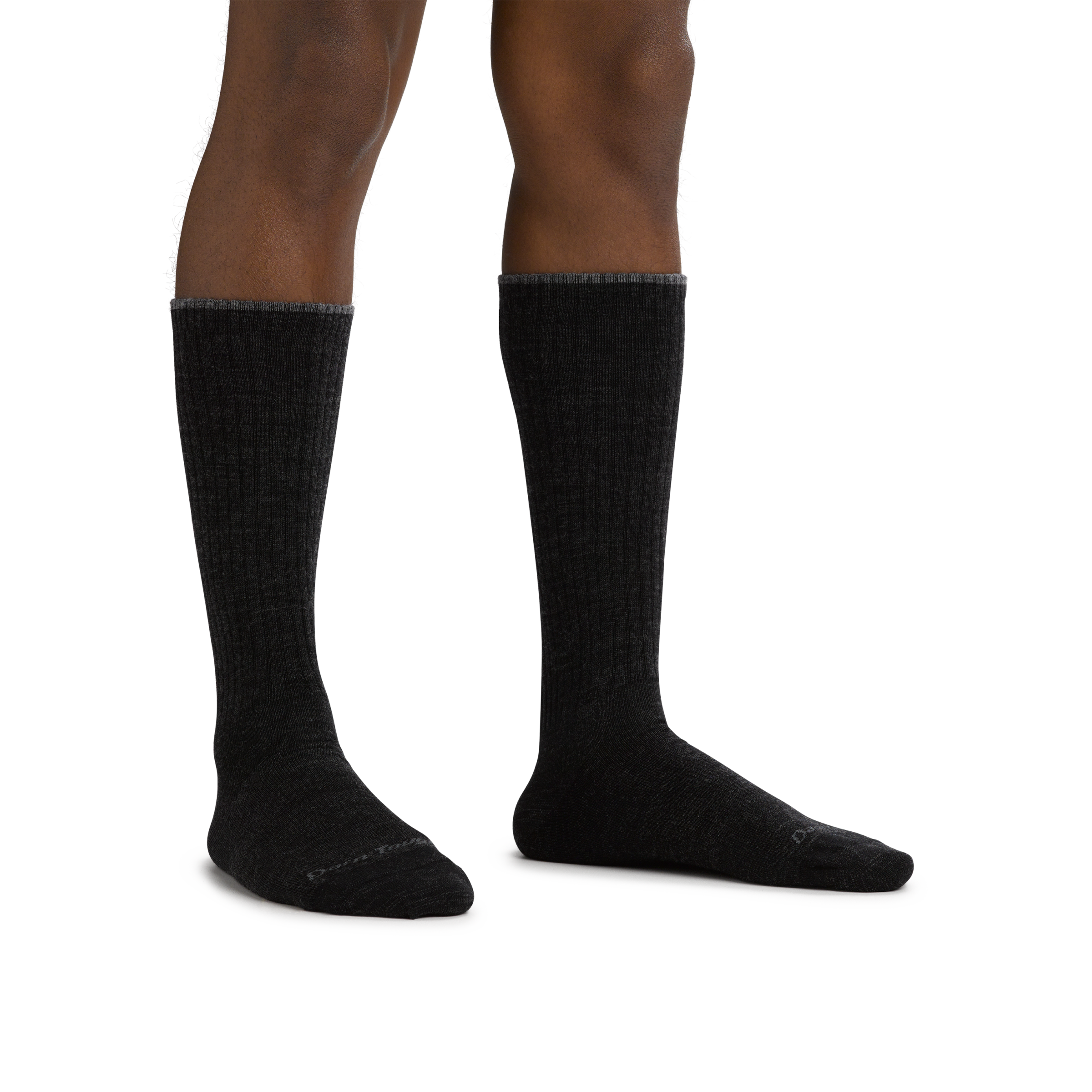 Man standing barefoot wearing The Standard Mid-Calf Lightweight Lifestyle Sock in Black