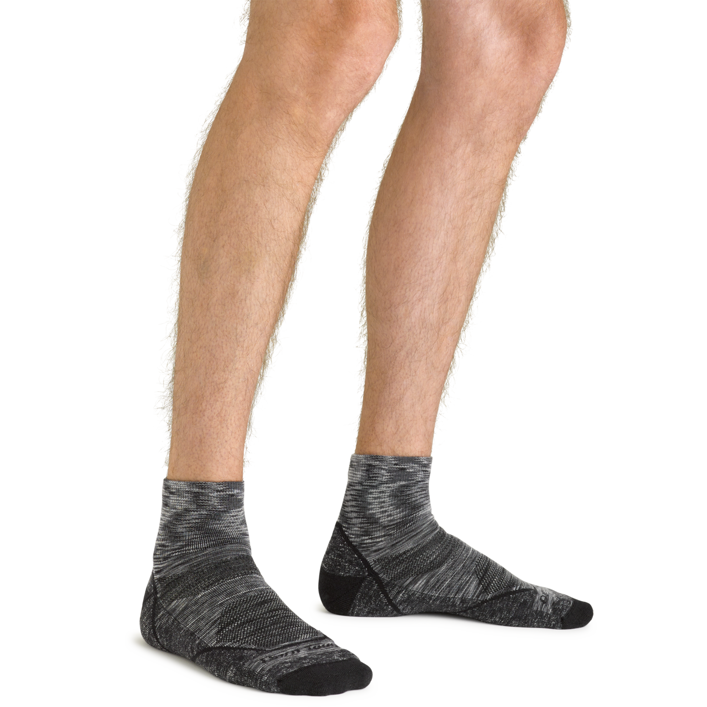Clos up shot of model wearing the men's light hiker quarter hiking sock in space gray with no shoes on