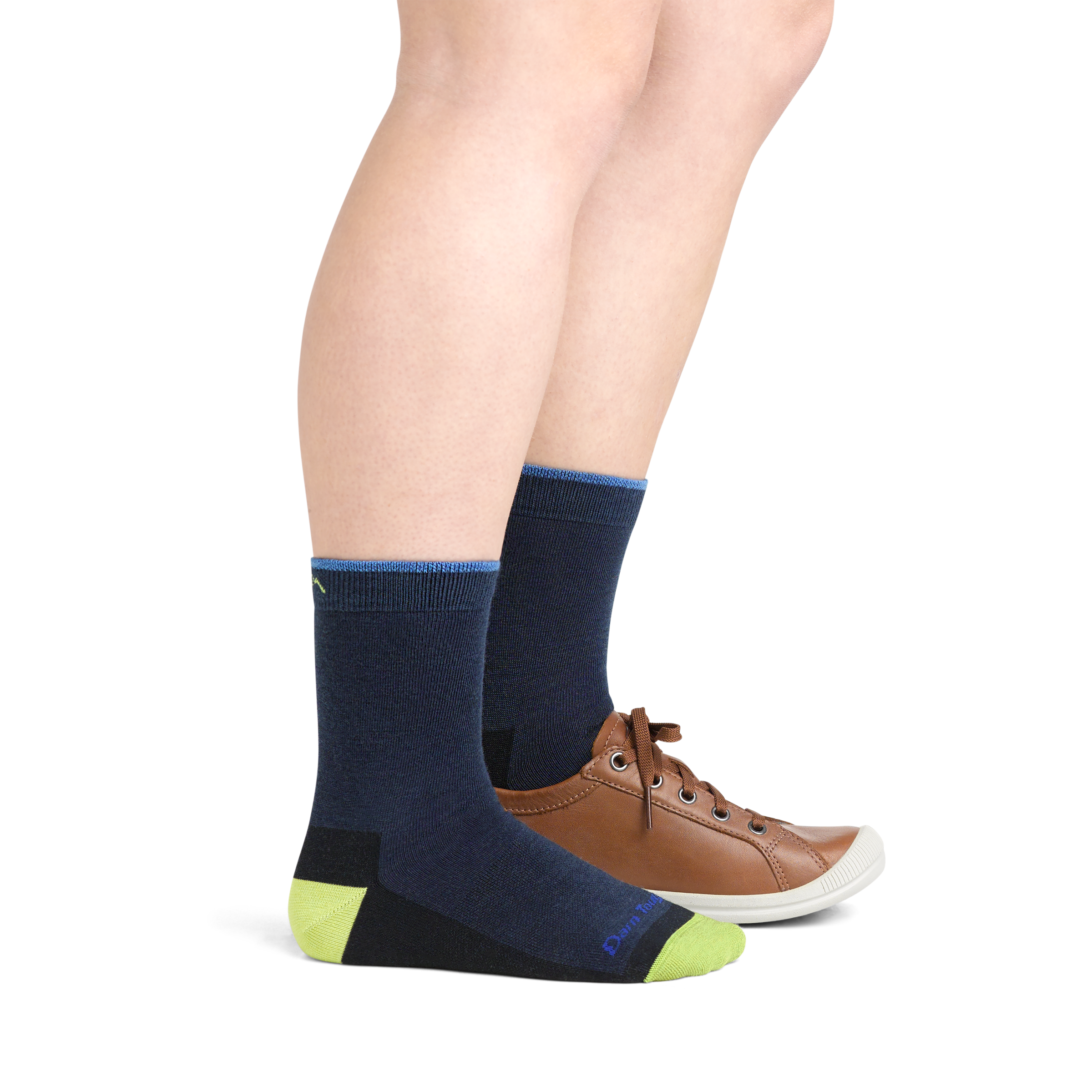 Model wearing 3044 Field Trip Kids Hiking socks in Eclipse colorway and brown leather sneaker on one foot