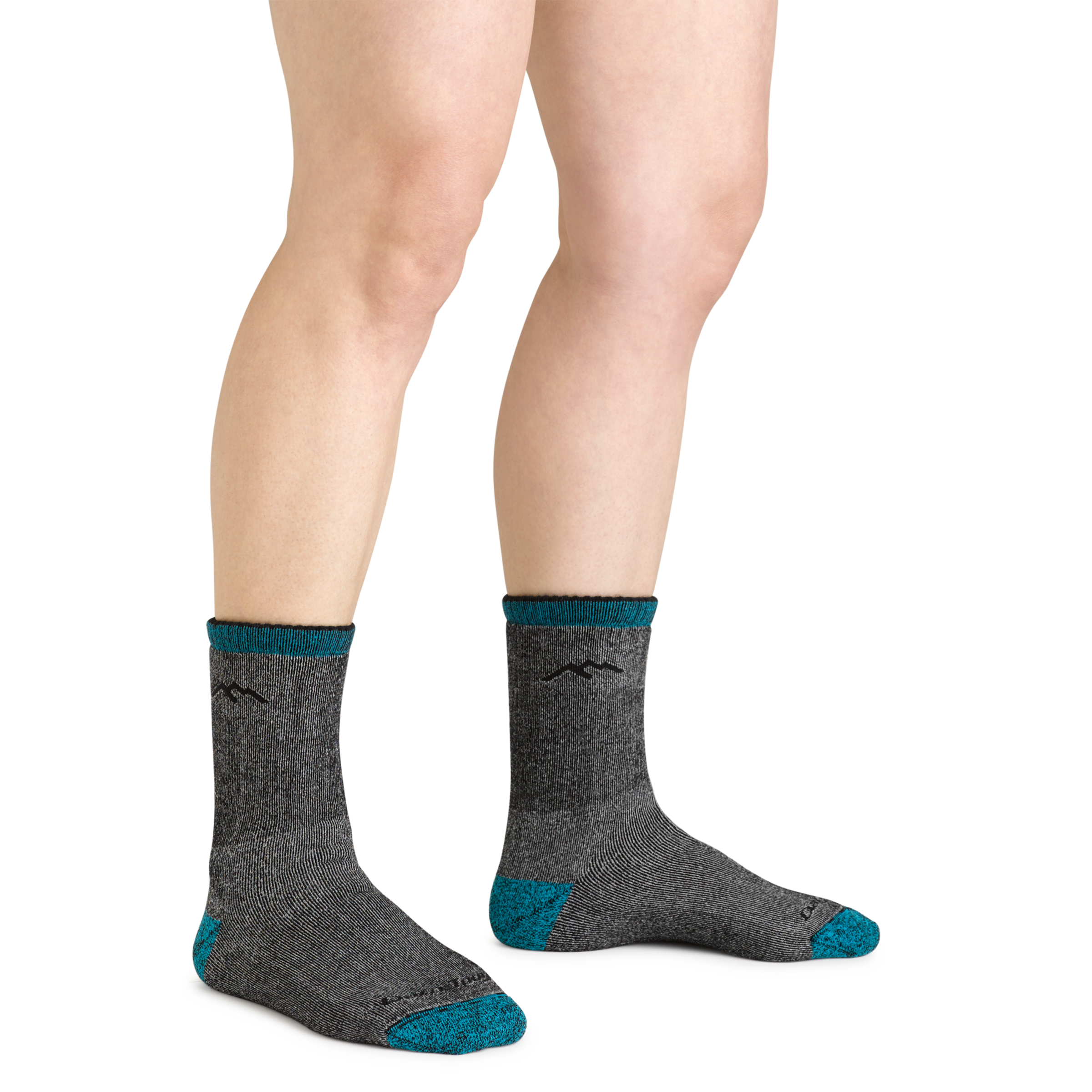 Close up shot of model wearing the women's mountaineering micro crew hiking socks in midnight with no shoes on