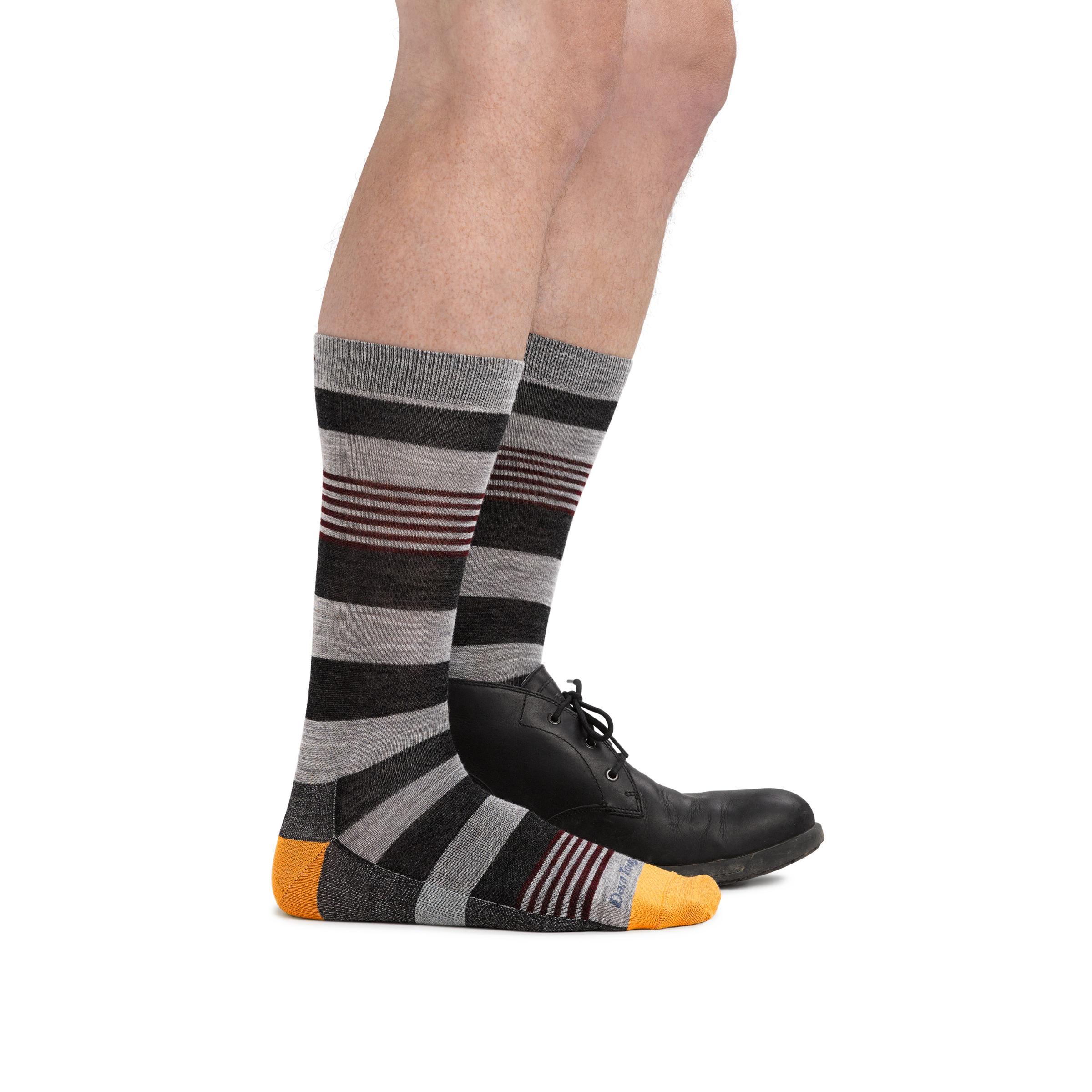 Male legs facing right wearing Oxford Crew Lightweight Lifestyle Socks in Gray, with back foot in a dress shoe