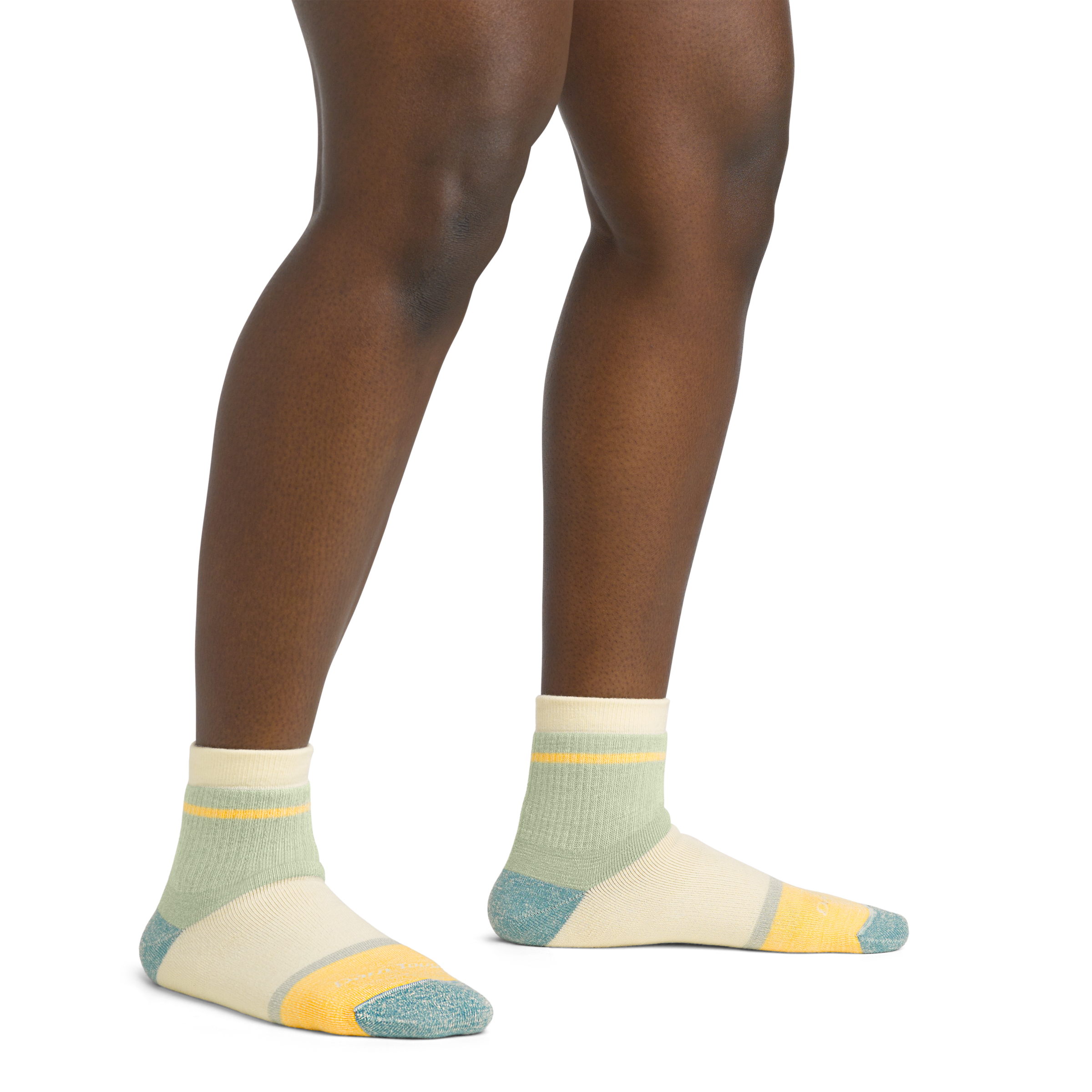 On model image of 6117 Women's Home Base socks in Pear colorway featuring blue, yellow, and green accents