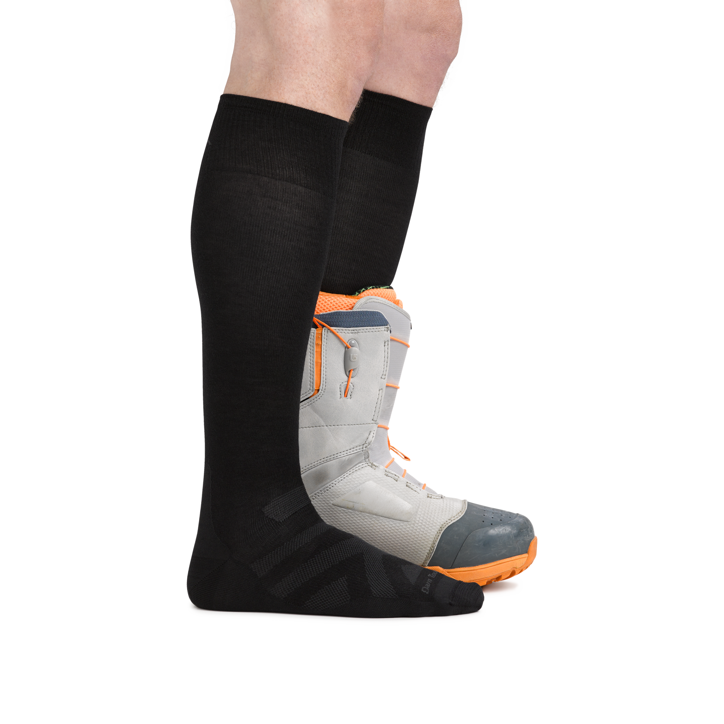 Man wearing RFL Over the Calf Ultralightweight Ski & Snowboard Sock in Black,  with back foot wearing a snowboard boot