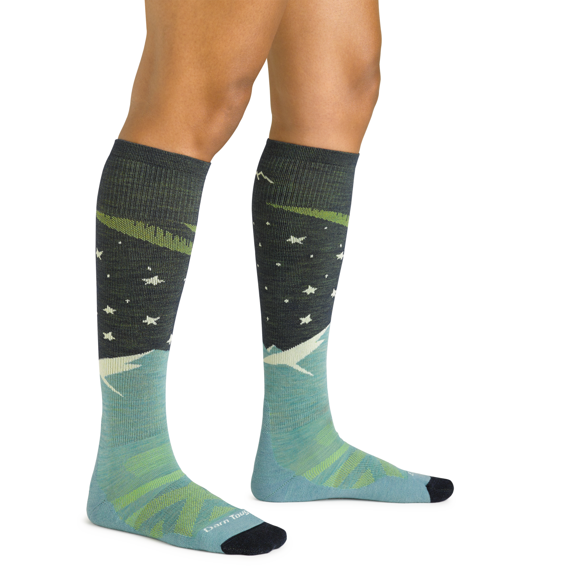 Close up studio shot of model wearing women's aurora over-the-calf lightweight ski & snowboard sock in aqua