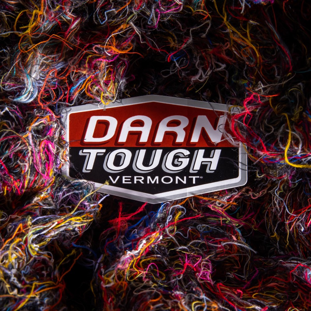 Darn Tough logo among Merino Wool fibers from making merino wool socks
