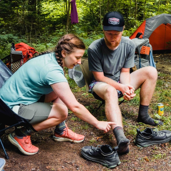 A Darn Tough employee showing an AT thru hiker features of hiking socks, doing some trail magic