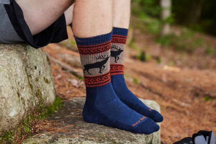 Shop Sock Gifts for Him - feet wearing socks with an elk on them