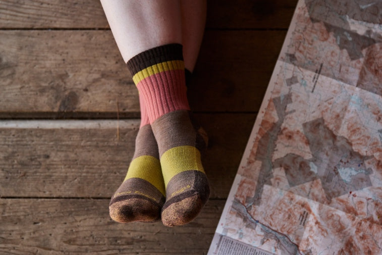 Shop New Socks from Darn Tough - crossed feet wearing new merino wool socks