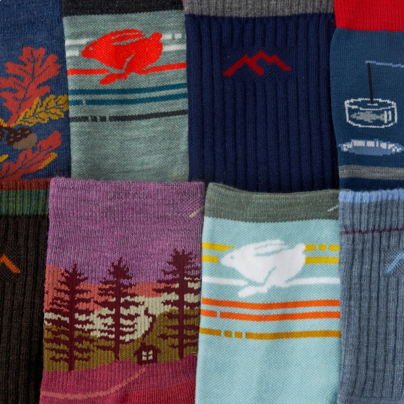 A row of Darn Tough socks in new colors laid out to show the patterns