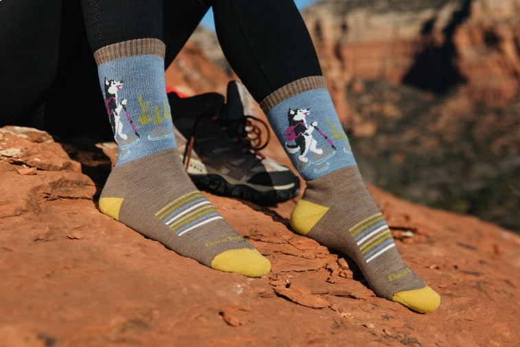 Shop Best Selling Socks - feet wearing hiking socks with a husky dog pattern